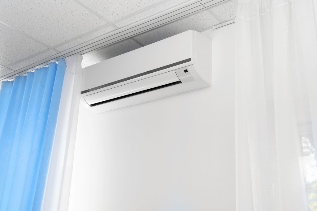 Ductless mini split system installed on the wall of a modern living room, providing efficient heating and cooling