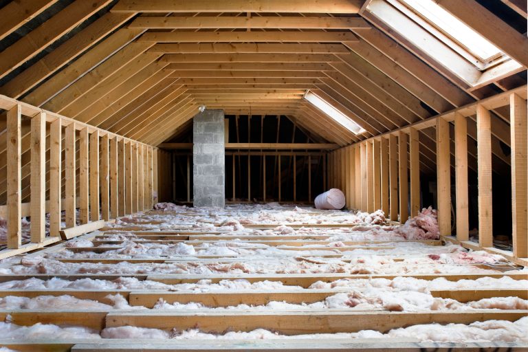 Close-up of attic insulation material being installed in a home.