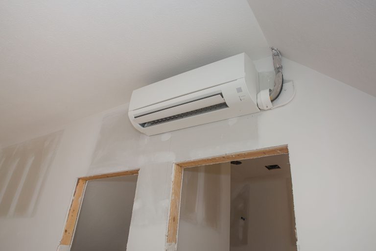 Close-up of a modern ductless mini split air conditioning unit installed on a wall, showcasing its sleek design and cooling functionality