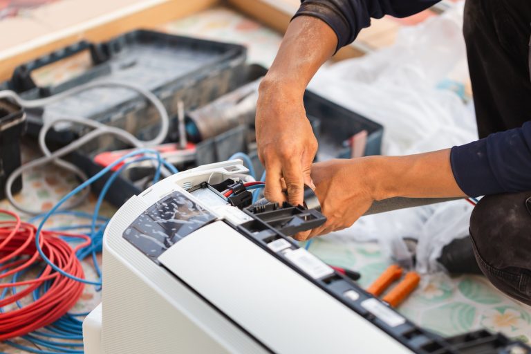 Technician responding to an air conditioning emergency, with tools and equipment ready for repair