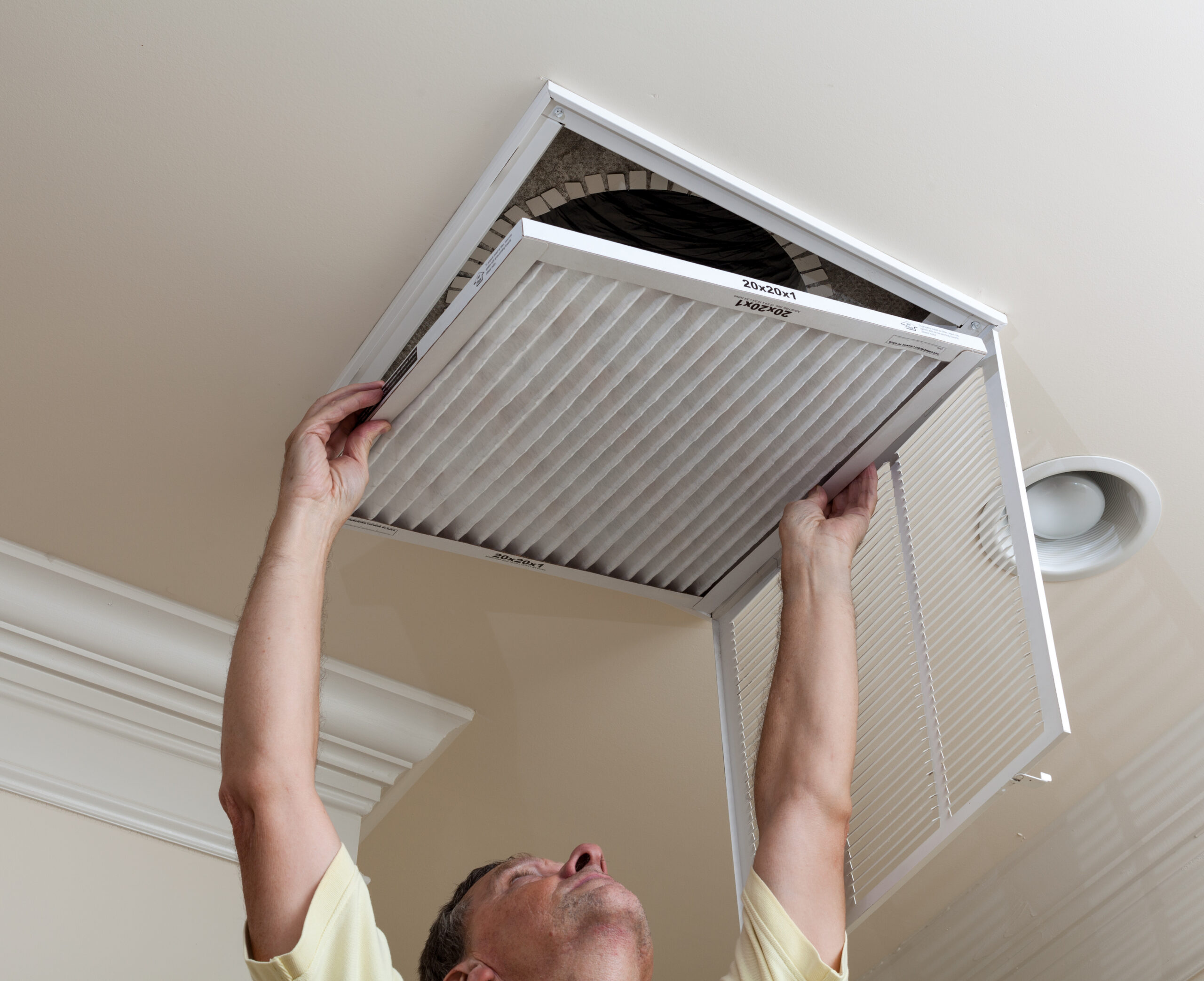 Homeowner replacing air filter